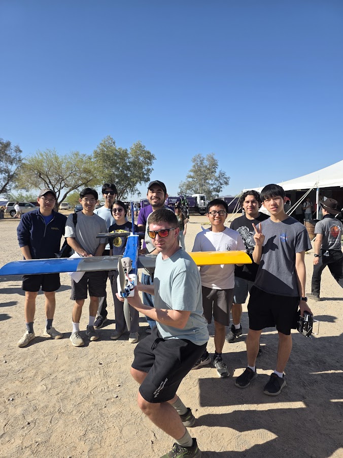 Team photo holding the plane in AZ